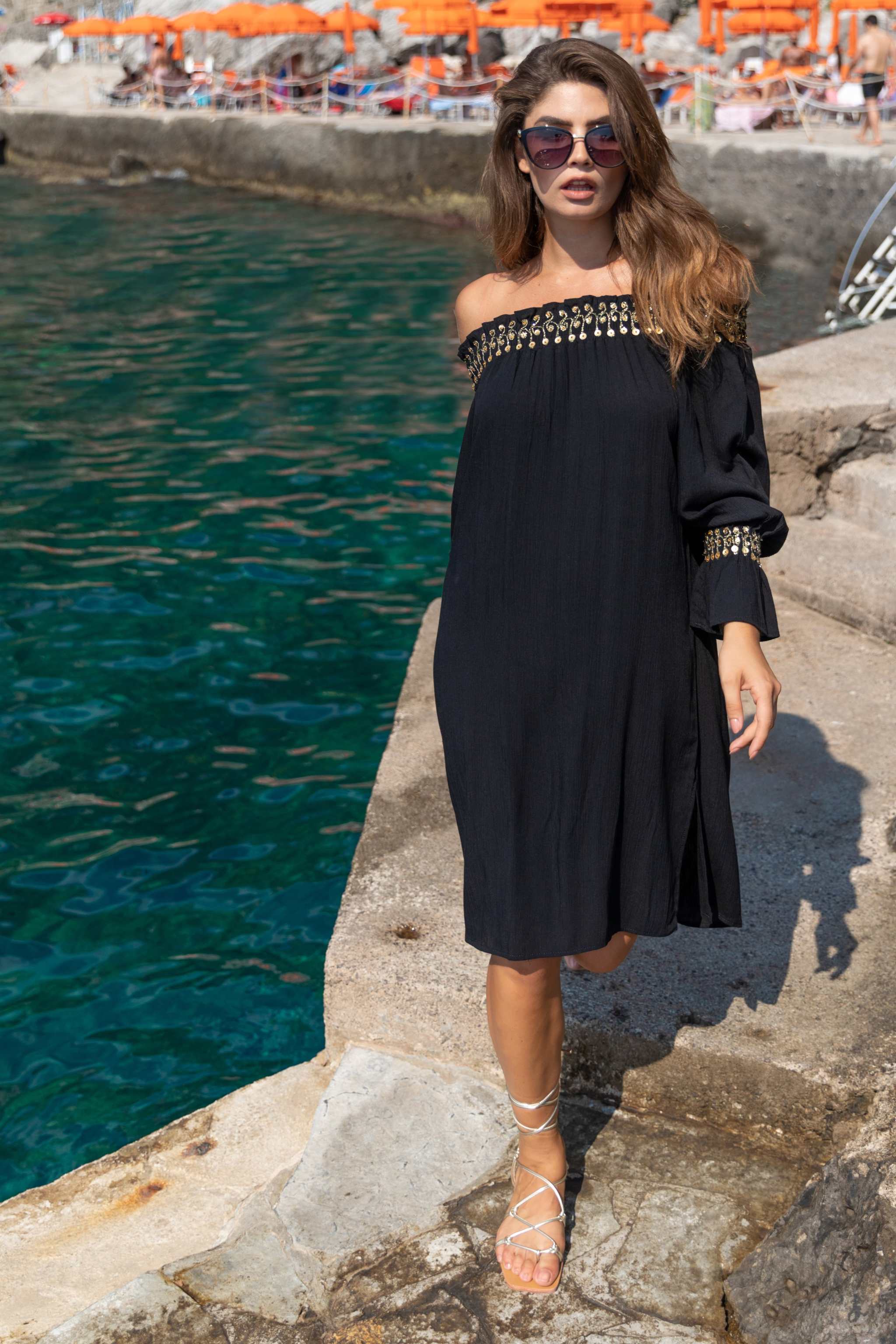 Black cotton off the shoulder holiday dresses in floaty black cotton by Lindsey Brown 
