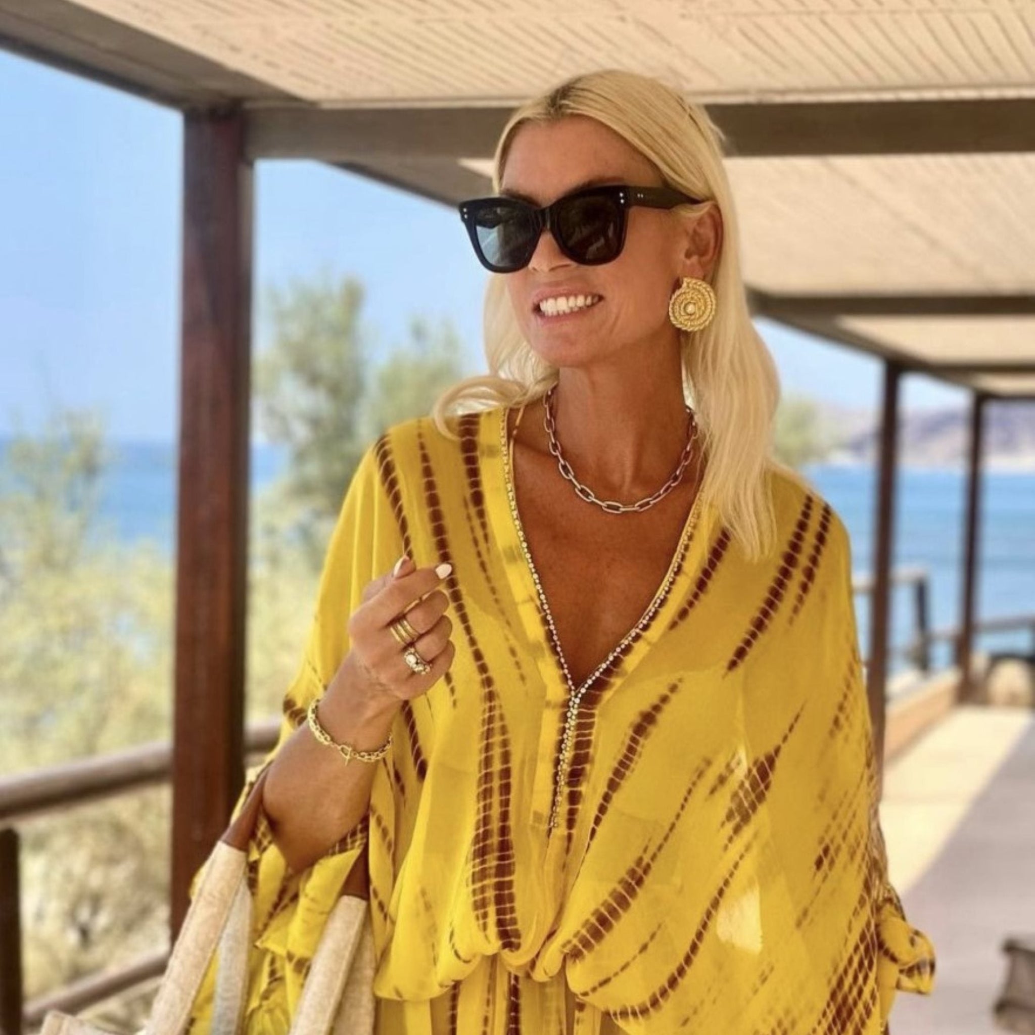 yellow silk designer kaftans to wear on holiday by Lindsey Brown luxury resort wear 