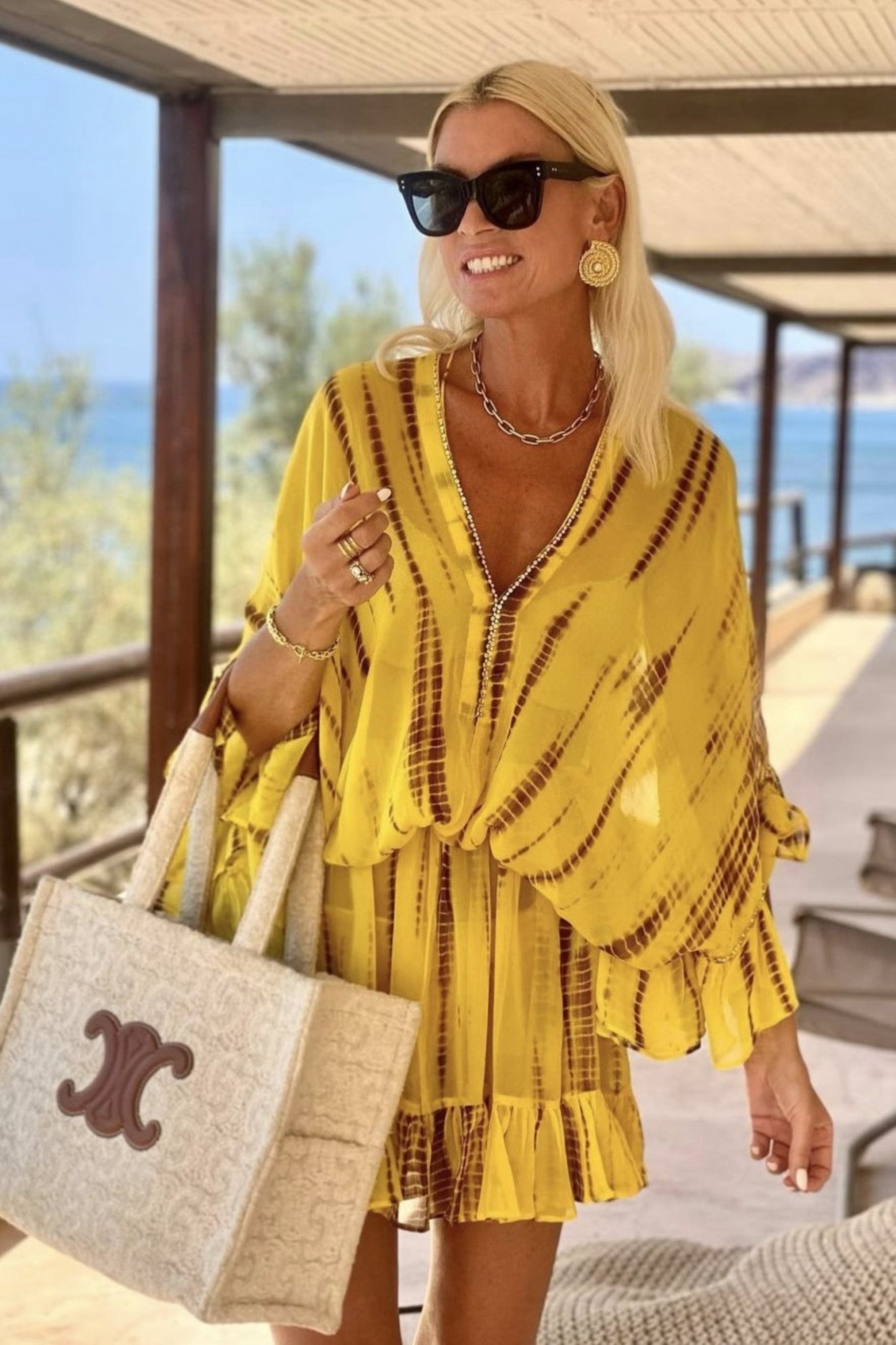 yellow silk designer kaftans to wear on holiday by Lindsey Brown luxury resort wear